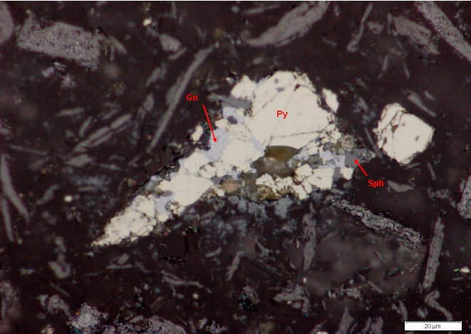 Photomicrograph of pyrite attached to sphalerite. Galena (Gn) locked in pyrite (Reflected Light).